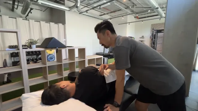 Dr. Michael Yip performing manual therapy at AdaptivMVMT Alhambra