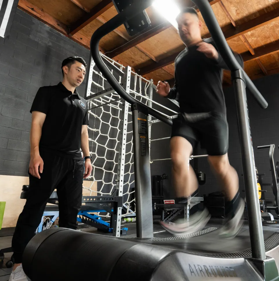 Michael watching a client run on an AirRunner treadmill